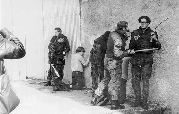 British Army snatch squad in William Street on a Sunday afternoon in Summer 1971. Those caught are brought back to be held behind army lines.